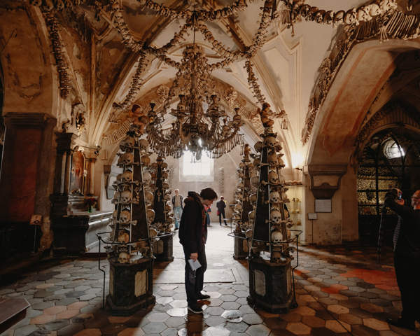 Weird Attractions - Man visiting the Sedlec Ossuary in Czech Republic