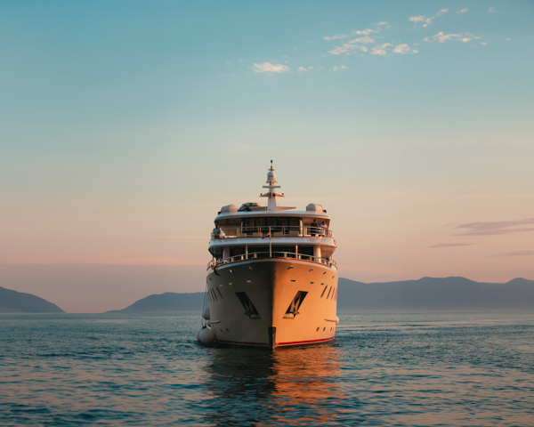 Cruise ship sailing through crystal-clear waters in Southeast Asia, showcasing stunning coastlines and tropical islands