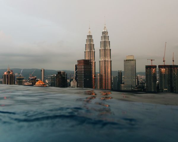 Cruise ship sailing through crystal-clear waters in Southeast Asia, showcasing stunning coastlines and tropical islands