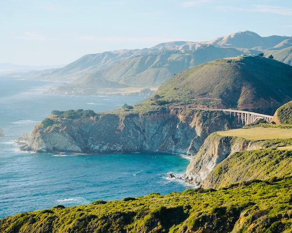 Scenic view of Big Sur Highway in California, showcasing stunning coastal cliffs and ocean vistas near Carmel-by-the-Sea.