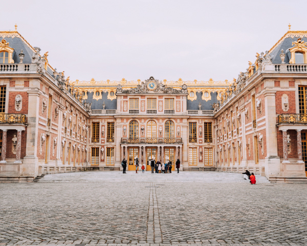 The iconic Palace of Versailles, featuring exquisite architecture and vibrant gardens, a must-visit on your Paris day trip.