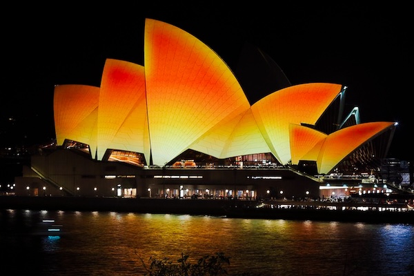 Sydney Opera House illuminated at night, adorned with vibrant lights for Diwali celebrations in Australia.