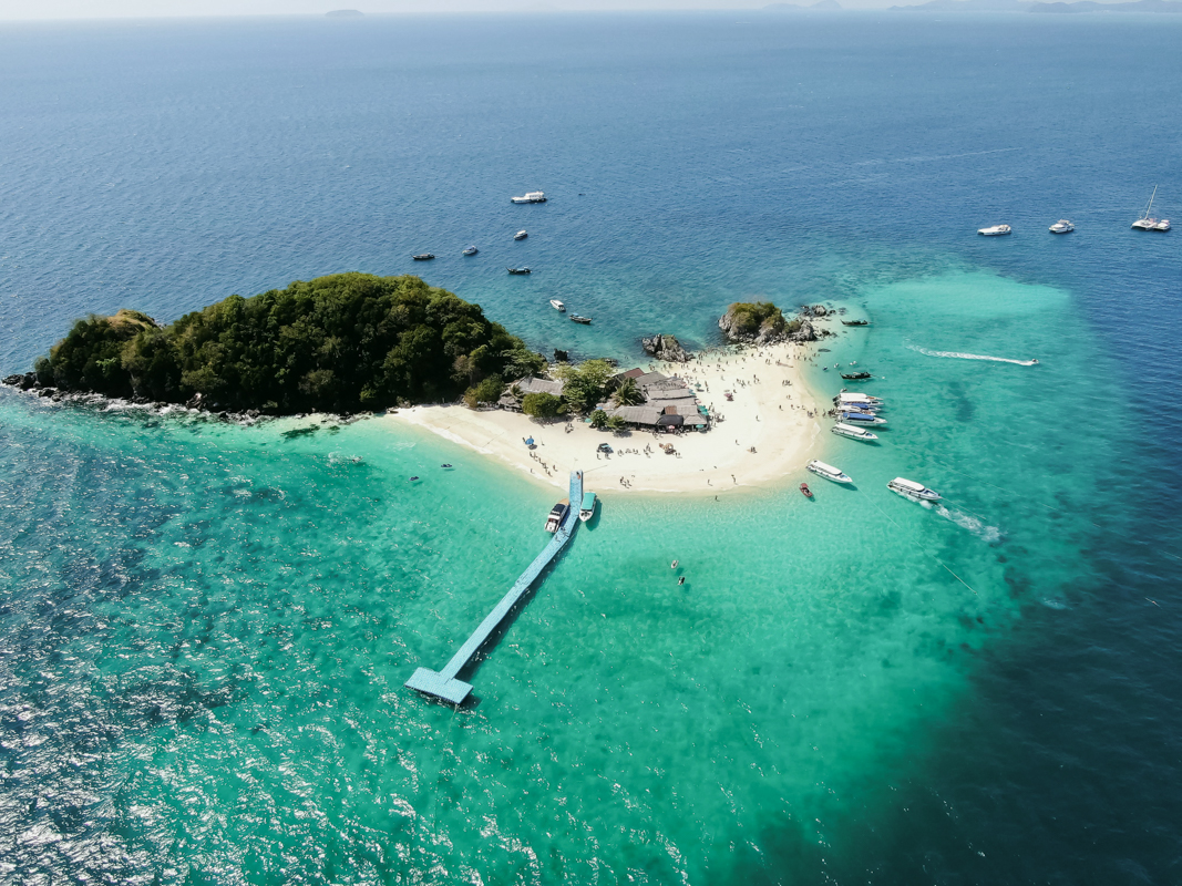 Narrow stone alleyway lined with traditional hanok houses in a historic Korean village, featuring wooden doors and tiled roofs.
