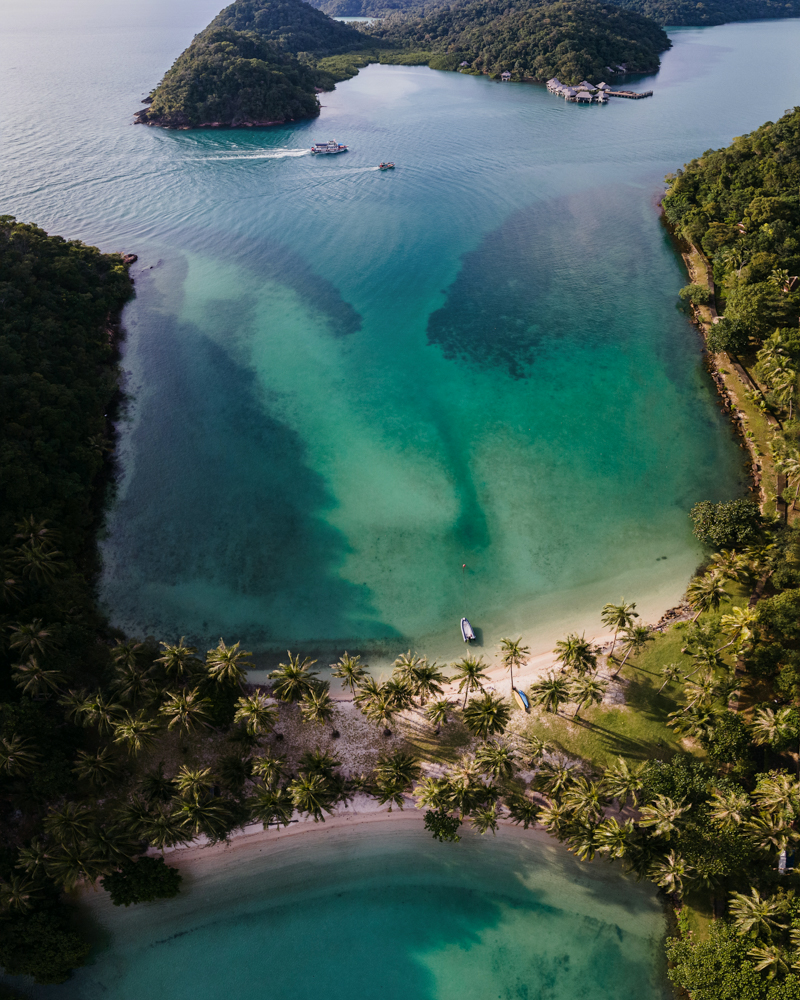 Couple dressed in traditional Korean hanbok strolling through the narrow stone-paved alleys of Bukchon Hanok Village in Seoul, surrounded by historic wooden houses.