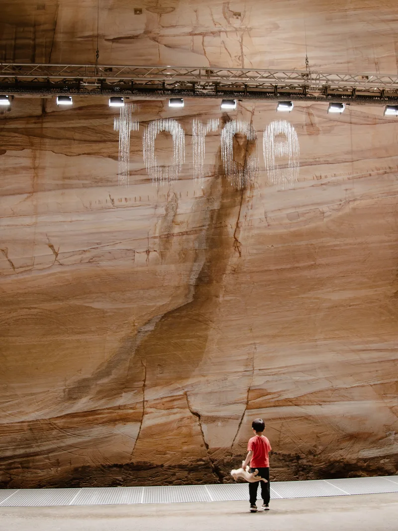A young boy observing a contemporary art exhibit at MONA in Hobart