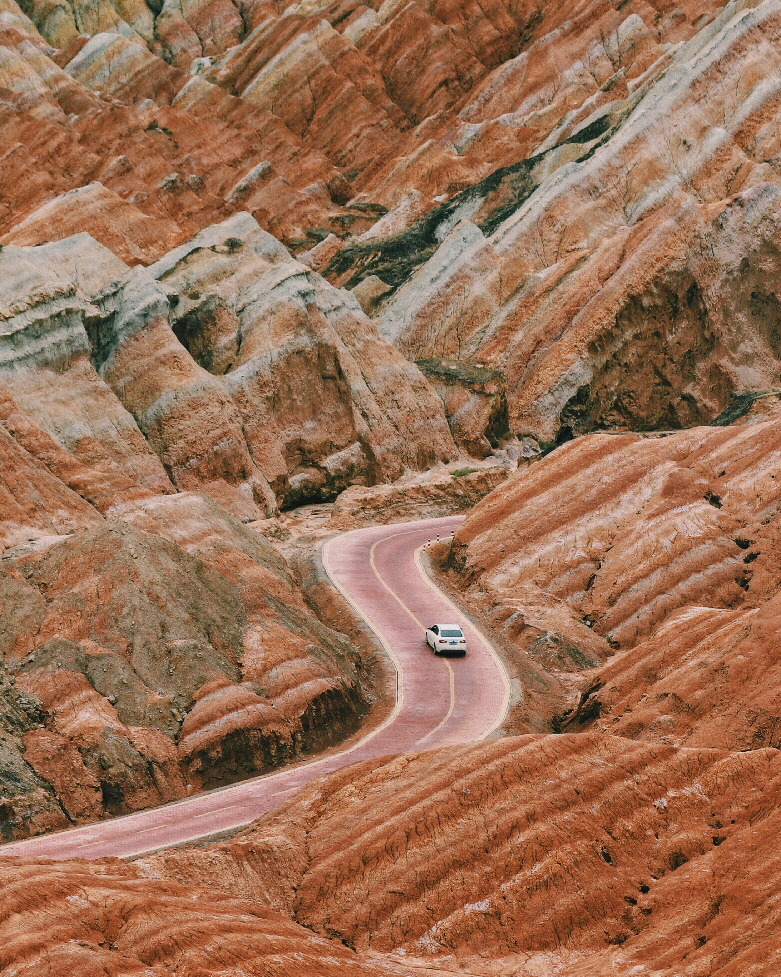 Mountain highway with rocky cliffs and pine trees, perfect for scenic drives in a rental car.