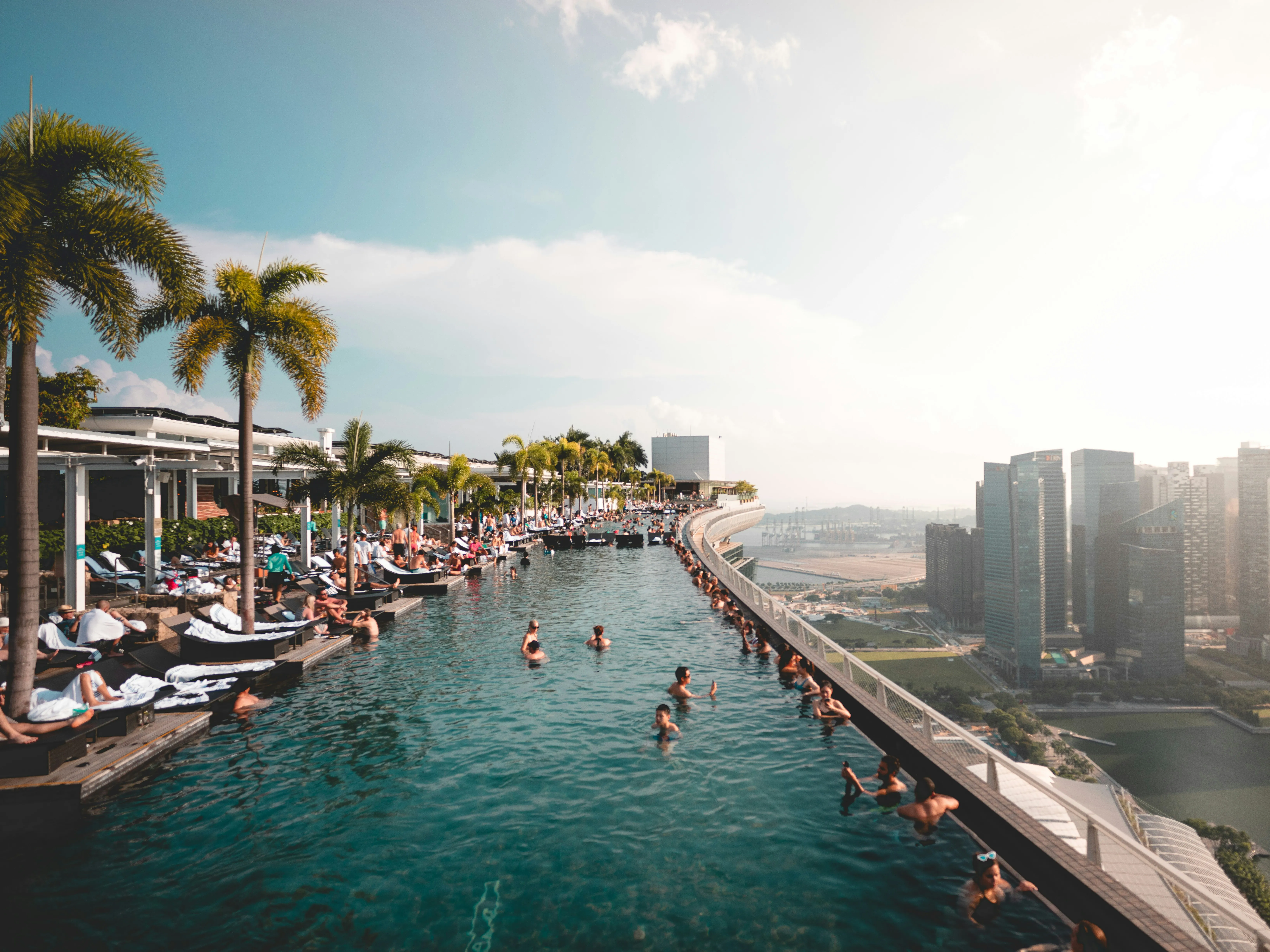 Rooftop infinity pool at Marina Bay Sands overlooking the Singapore city skyline.