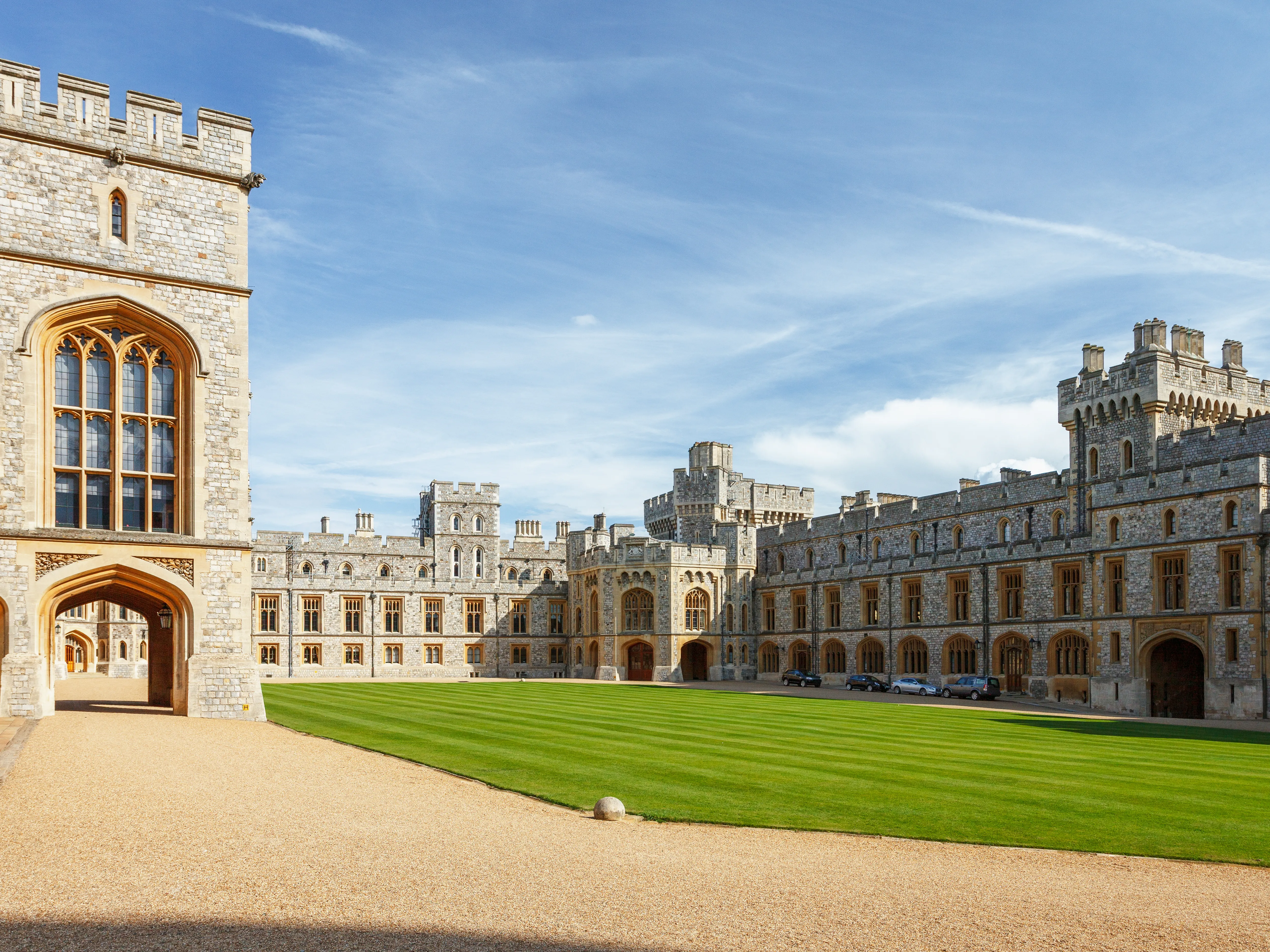 Windsor Castle quadrangle with manicured lawn and surrounding medieval buildings, one of the best day trips from London.
