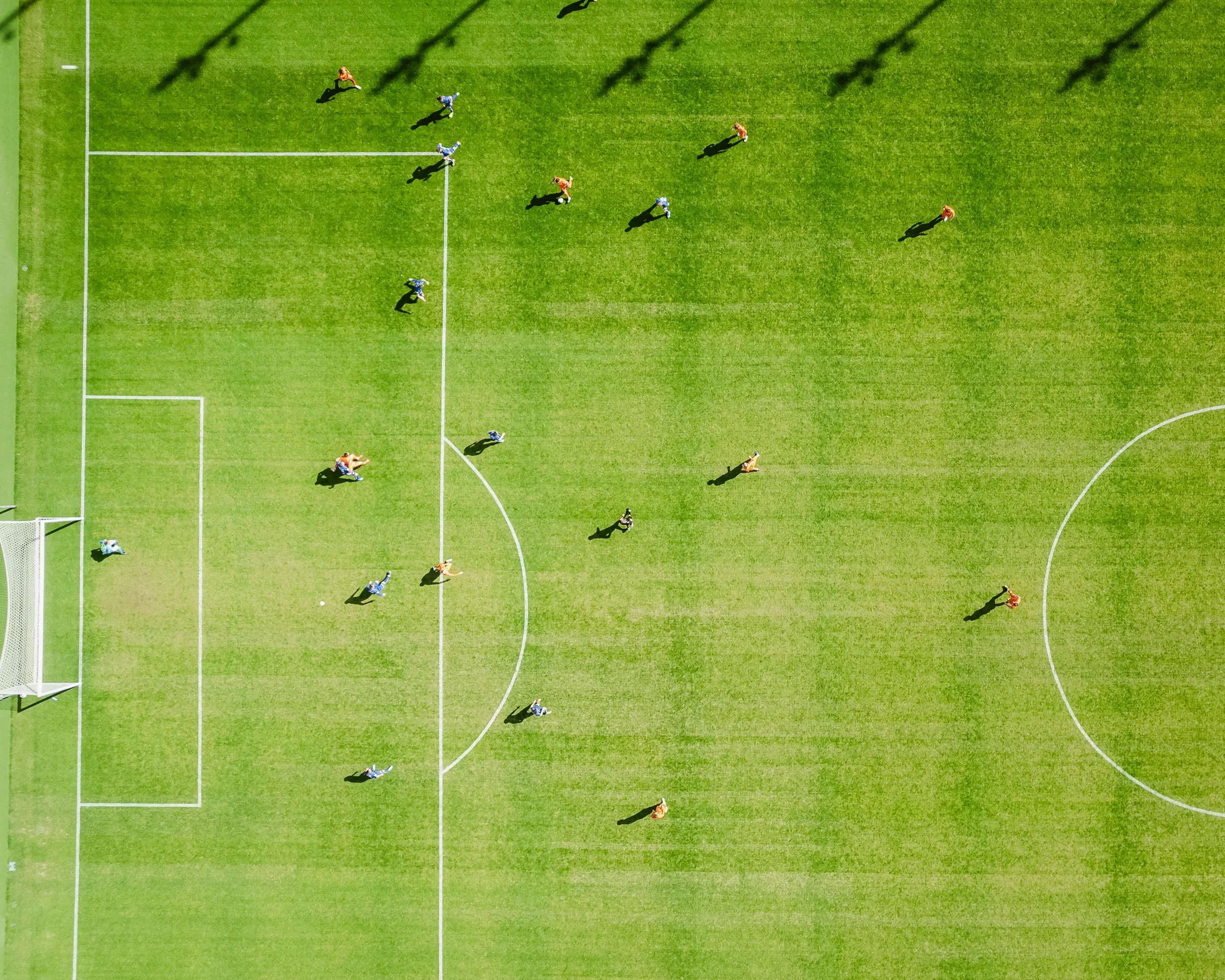 Aerial view of football players competing on a pitch during a match ahead of FIFA World Cup 2026