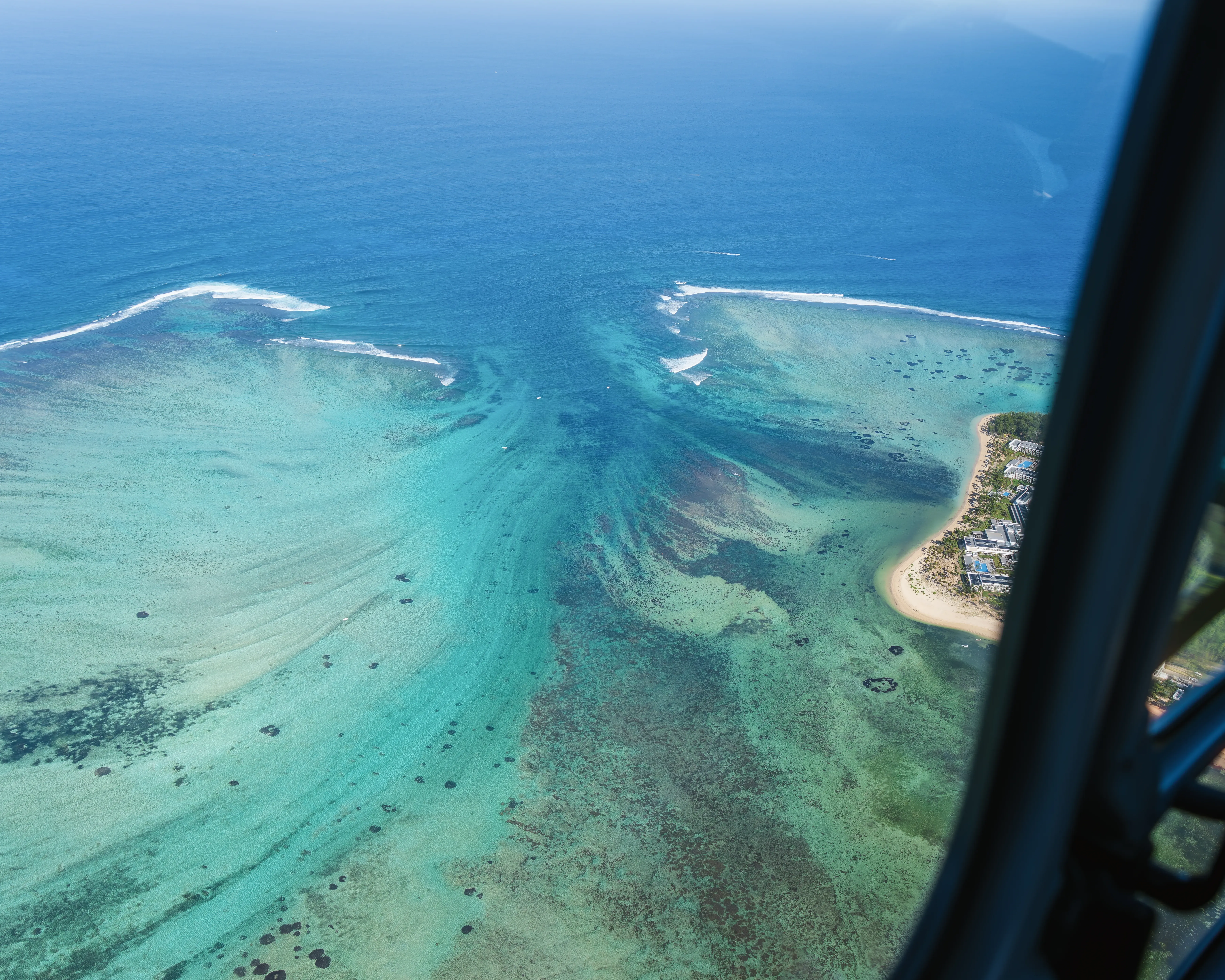Aerial view of Mauritius lagoon, coral reef and white sand coastline, one of the best tropical destinations to visit in September from Australia